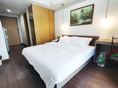 a large white bed in a hotel room at Accommodation Service in Manila