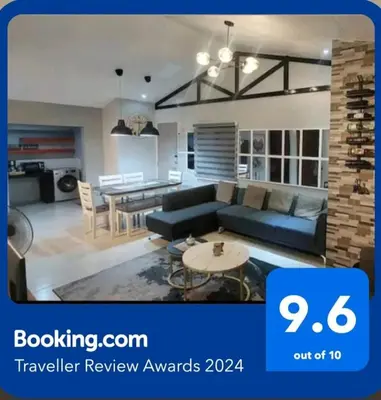 a living room with a couch and a table at Lax Uno 2 bedroom home with Parking, Wi-Fi, NetFlix and Airconditioned Rooms and Shower Heater in Antipolo
