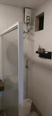 a bathroom with a shower and a toilet at Lax Uno 2 bedroom home with Parking, Wi-Fi, NetFlix and Airconditioned Rooms and Shower Heater in Antipolo
