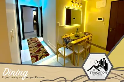 a small dining room with a table and a mirror at Luxurious 2 Bedroom Family Suite plus Maid Rm in Eastwood City in Manila