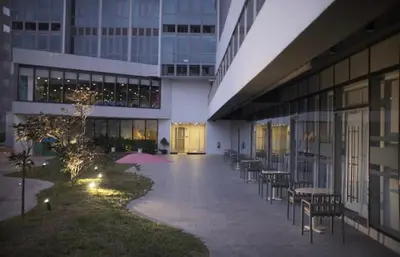 a hallway of a building with tables and chairs at Luxurious 2 Bedroom Family Suite plus Maid Rm in Eastwood City in Manila