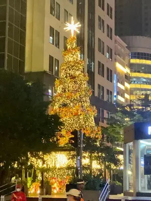 a christmas tree in the middle of a city at Luxurious 2 Bedroom Family Suite plus Maid Rm in Eastwood City in Manila