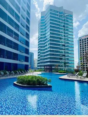 a large pool in front of some tall buildings at Apartment Condo in Air Residences Makati wifi Netflix Disney, pool & mall in Manila