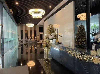 a lobby with a christmas tree on the wall at Apartment Condo in Air Residences Makati wifi Netflix Disney, pool & mall in Manila