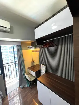 an office with a desk and a computer in a room at Apartment in Air Residences, Makati with wifi, Netflix, pool, mall and more in Manila