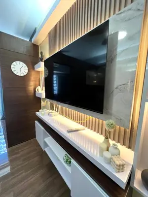 a bathroom with a large television on a wall at Apartment in Air Residences, Makati with wifi, Netflix, pool, mall and more in Manila