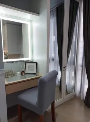 a desk with a chair and a mirror at The Florence at McKinley Hill in Manila