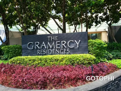 a sign for the germanagency reserves in front of flowers at The Gramercy Residences in Manila