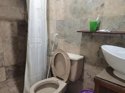 a bathroom with a white toilet and a sink at Accommodation services in Manila