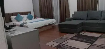a living room with a couch and a bed at Accommodation services in Manila