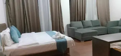 a bedroom with a bed and a chair and a couch at Accommodation services in Manila