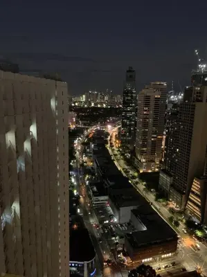 a view of a city at night with traffic at BCP Homes in Manila