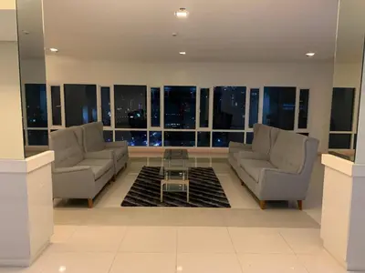a living room with two couches and a table at BCP Homes in Manila