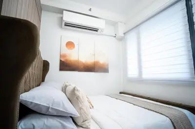 a bedroom with a bed and a window at Tatet Staycation Short Walk to SM MOA in Manila