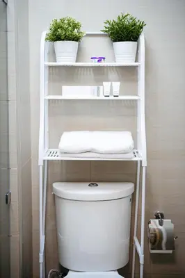 a white shelf above a toilet in a bathroom at Tatet Staycation Short Walk to SM MOA in Manila