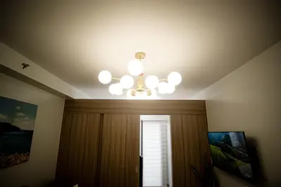 a chandelier and a window in a room at Tatet Staycation Short Walk to SM MOA in Manila