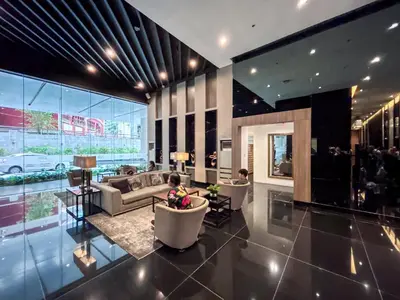 a large living room with two children sitting in chairs at Newly Turned 0ver Cond0- Air Makati 1BR with Balcony in Manila