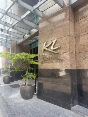 a building with a sign on the side of it at Family KL Greenbelt Makati in Manila