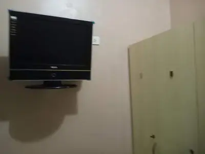 a flat screen tv hanging on a wall at Budget Condotel in Manila