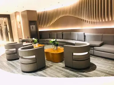 a lobby with couches and a table and chairs at Shore Residence condotel,Pasay city Philippines in Manila