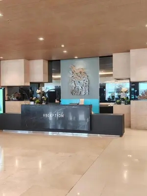 a hotel lobby with a reception desk with a tiger on the wall at Shore Residence condotel,Pasay city Philippines in Manila