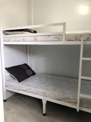 a bunk bed with a book on the bottom bunk at Sebastian’s Crib F in Dasmariñas