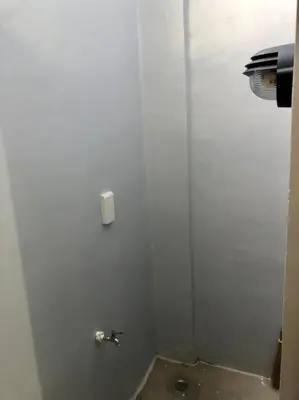 a bathroom with a white door with a faucet at Sebastian’s Crib F in Dasmariñas