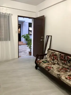 a living room with a couch and a door at Sebastian’s Crib F in Dasmariñas