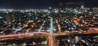 a city lit up at night with traffic at Sea-Sky Perch Suite in Manila