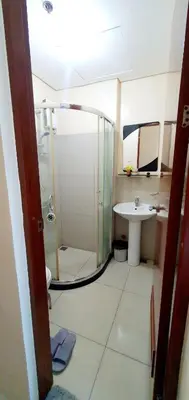 a bathroom with a shower and a sink at Sea-Sky Perch Suite in Manila