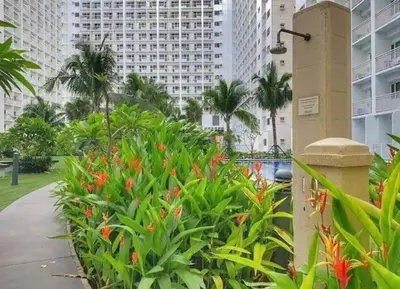 a garden in the middle of a city with tall buildings at simple and affordable staycation at SHORE RESIDENCES in Manila