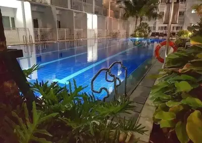 a large swimming pool with blue water in a building at simple and affordable staycation at SHORE RESIDENCES in Manila