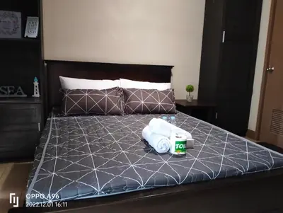 a bedroom with a bed with two towels on it at RQUI CONDOTEL INFRONT OF NAIA TERMINAL 3 in Manila