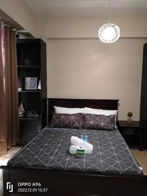 a bedroom with a bed with towels on it at RQUI CONDOTEL INFRONT OF NAIA TERMINAL 3 in Manila