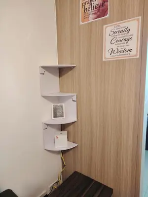 a wall with shelves with a laptop on it at Shore One Condotel At Mall of Asia, Philippines in Manila