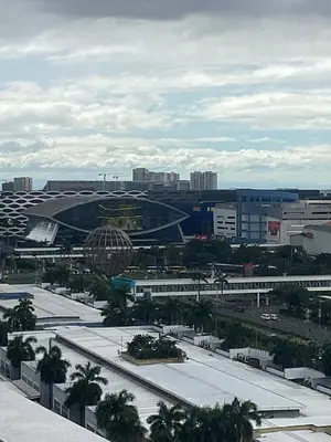 a view of a stadium in a city with a train at Shore One Condotel At Mall of Asia, Philippines in Manila