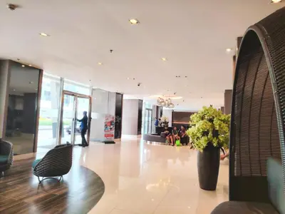a lobby with a vase of flowers in a building at Shore One Condotel At Mall of Asia, Philippines in Manila