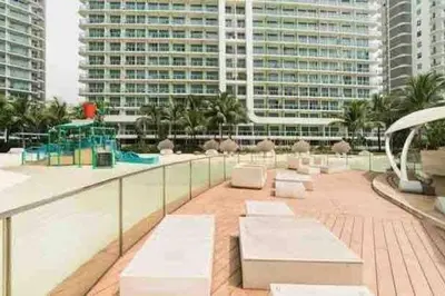 a patio with white benches on top of a building at Cozy 1BR cityview with Balcony and near Airport in Manila