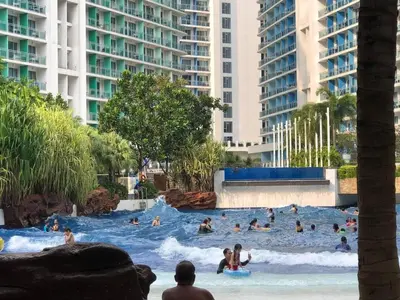 a group of people in the water at a resort at Cozy 1BR cityview with Balcony and near Airport in Manila