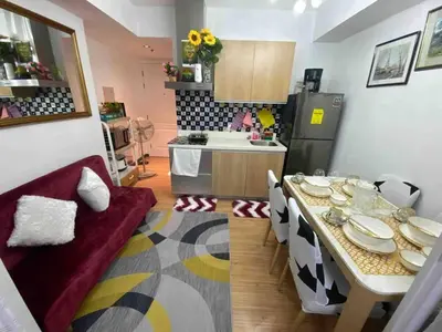 a kitchen with a table with plates on it at Cozy 1BR cityview with Balcony and near Airport in Manila