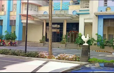 a building with a bird statue in front of a street at 101 Newport Boulevard near NAIA Terminal 3 in Manila