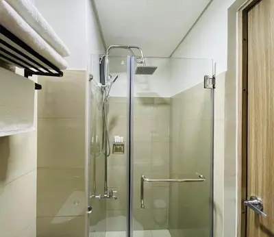 a shower with a glass door in a bathroom at Sakan 5-Star Quality Condotel in Manila