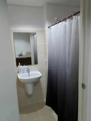 a bathroom with a sink and a shower at Grand Riviera Suites, US Embassy Comfy, Affordable Studio in Roxas Blvd, Ermita Manila in Manila