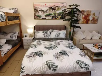 a bedroom with a bed with a black and white comforter at A2J Luxury Studio Near Venice Mall BGC Taguig in Manila