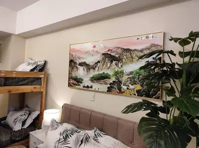 a living room with a painting hanging on the wall at A2J Luxury Studio Near Venice Mall BGC Taguig in Manila