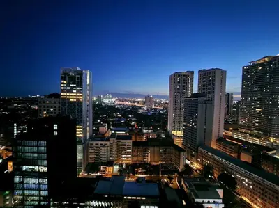 a view of a city skyline at night at Modern Hotel-type Studio near Greenbelt Netflix 100mbps in Manila