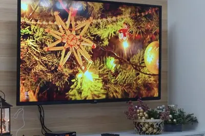 a flat screen tv hanging on a wall at A cozy 2 bedroom condo in Metro in Manila