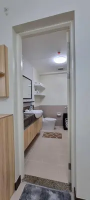 a bathroom with a tub and a sink and a toilet at A cozy 2 bedroom condo in Metro in Manila