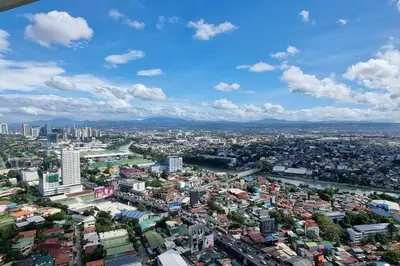 an aerial view of a city with a river and buildings at A cozy 2 bedroom condo in Metro in Manila