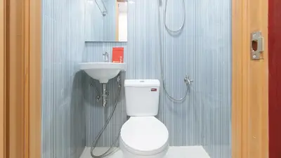 a bathroom with a toilet and a sink at RedDoorz @ El Grande Inn Santa Cruz Manila in Manila